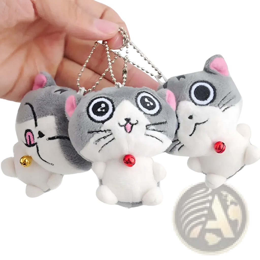 Plush cat keychain featuring cute gray and white kitten design with pink ears black eyes and small red and gold bells