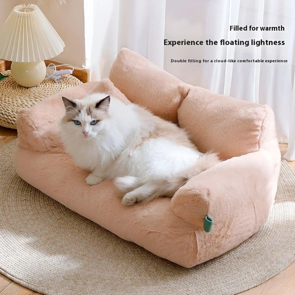 Soft peach-colored plush cat sofa bed with cushioned armrests and cozy cloud-like design for warm winter lounging
