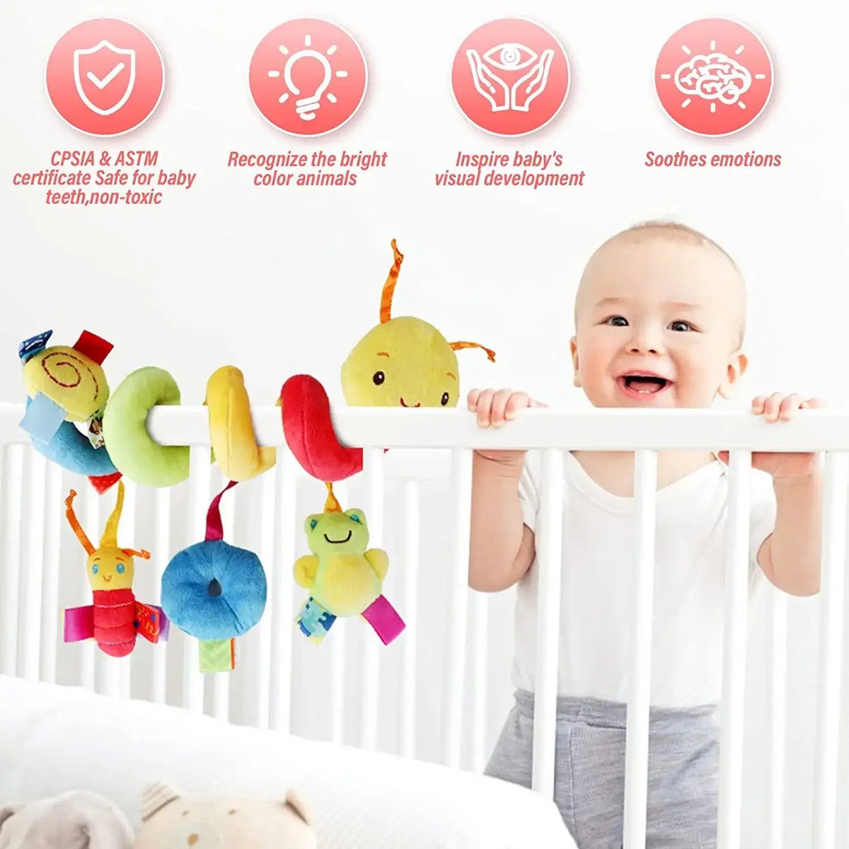 Colorful plush caterpillar baby car seat toy with soft bright fabric and friendly cartoon faces hanging from a white crib rail