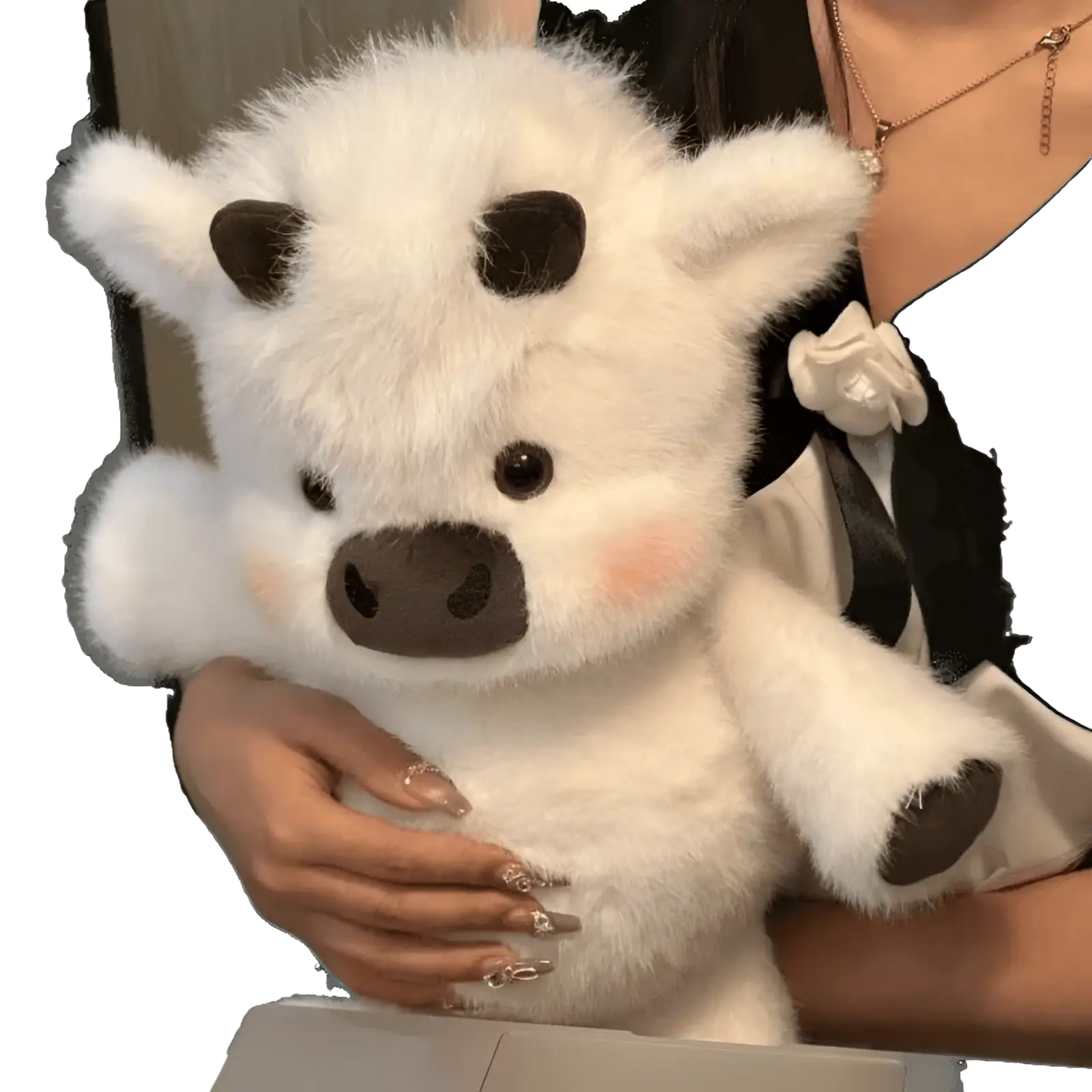 A plush white cow with black spots and a brown nose soft stuffed animal toy held gently for kids