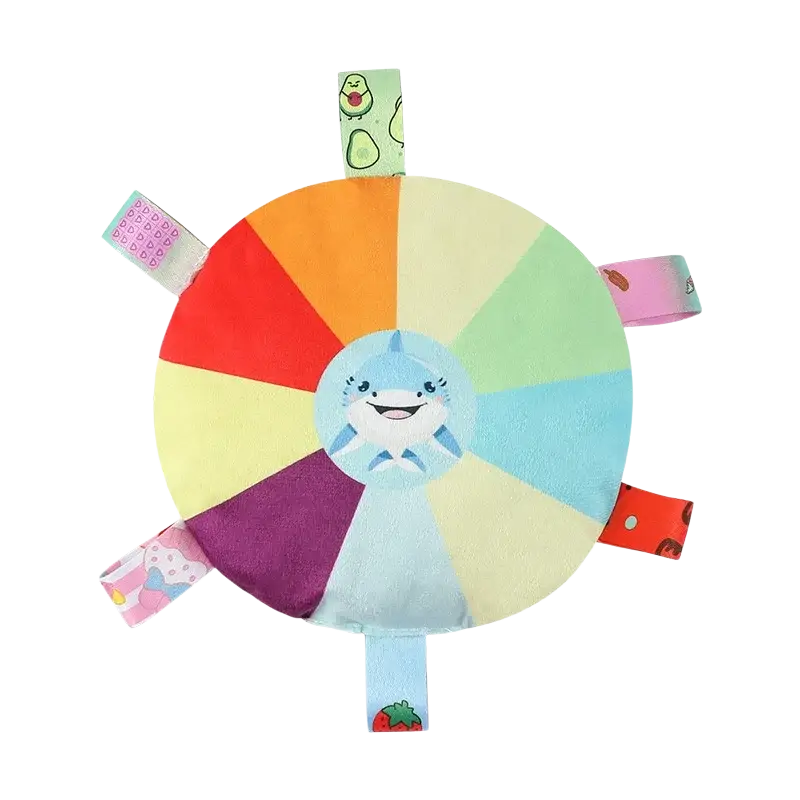 A soft circular plush dog ball toy with a smiling blue shark and colorful fabric segments for furry children