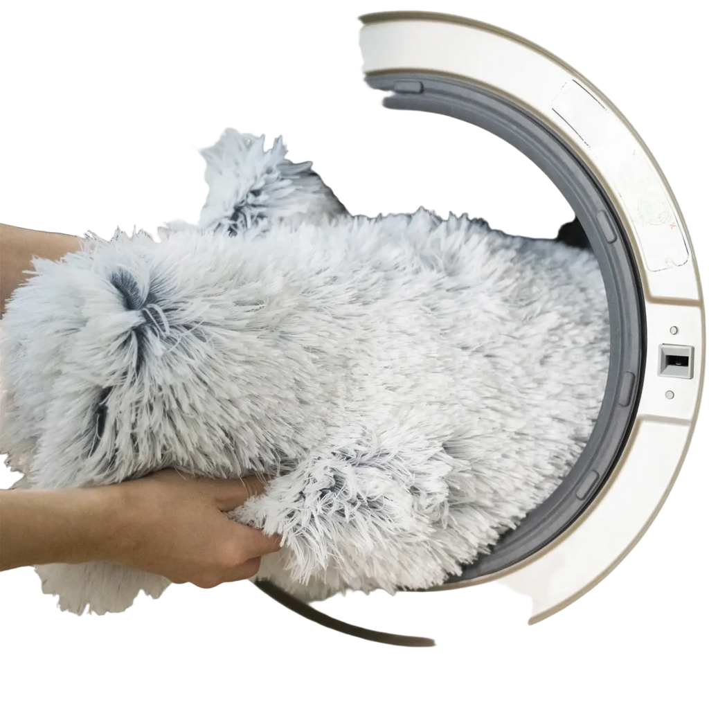 A plush white and gray fluffy dog bed sofa made of soft faux fur with a shaggy texture for warmth and comfort