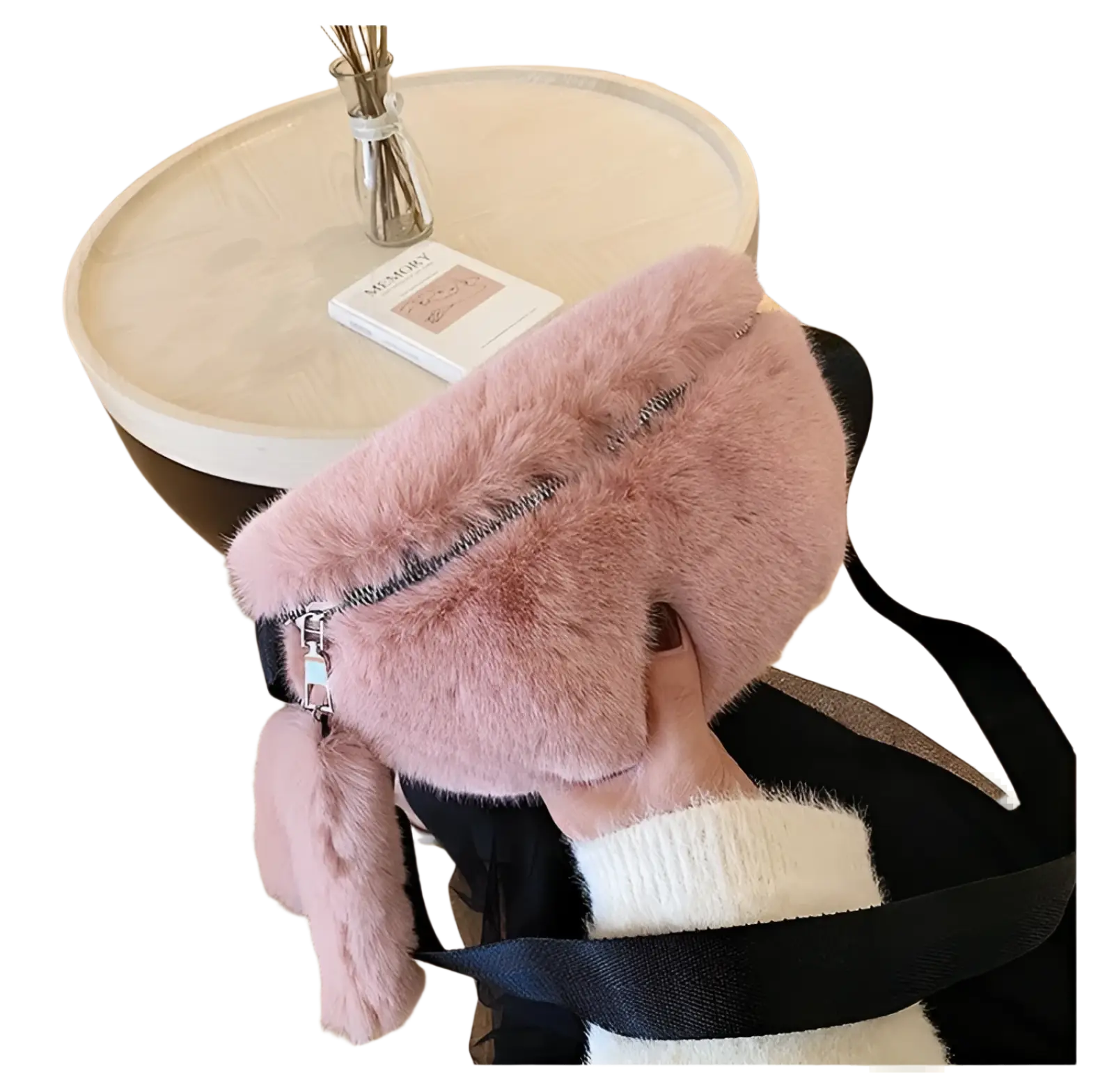 Plush faux fur fanny pack in soft pink with a black strap and zipper pull for crossbody messenger use