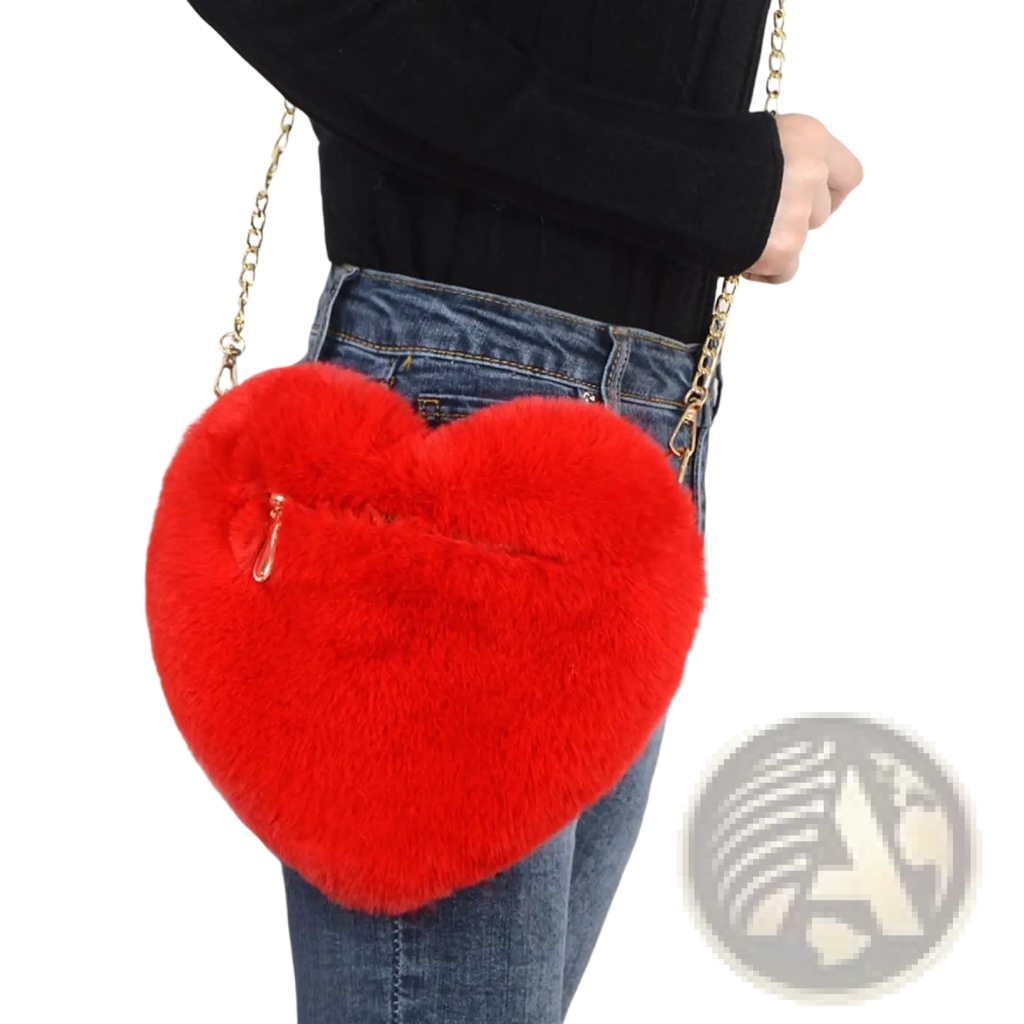 A vibrant red plush faux fur heart shaped crossbody bag with gold chain strap and zipper closure