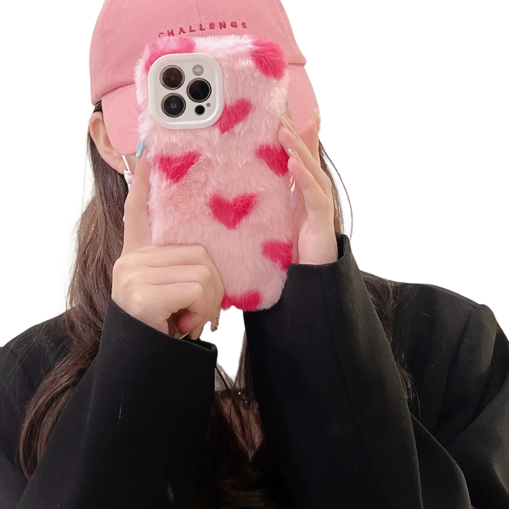 Pink fuzzy iphone case with red heart patterns showing the back side of the plush heart cover