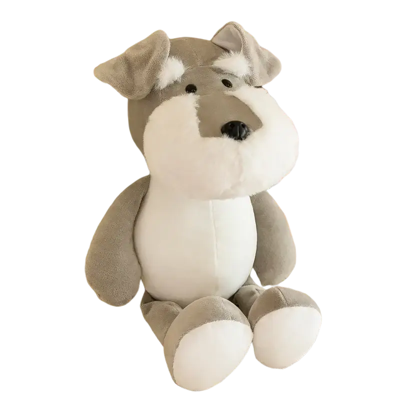 A soft gray and white plush schnauzer dog toy with black button eyes and nose sitting on a lace tablecloth