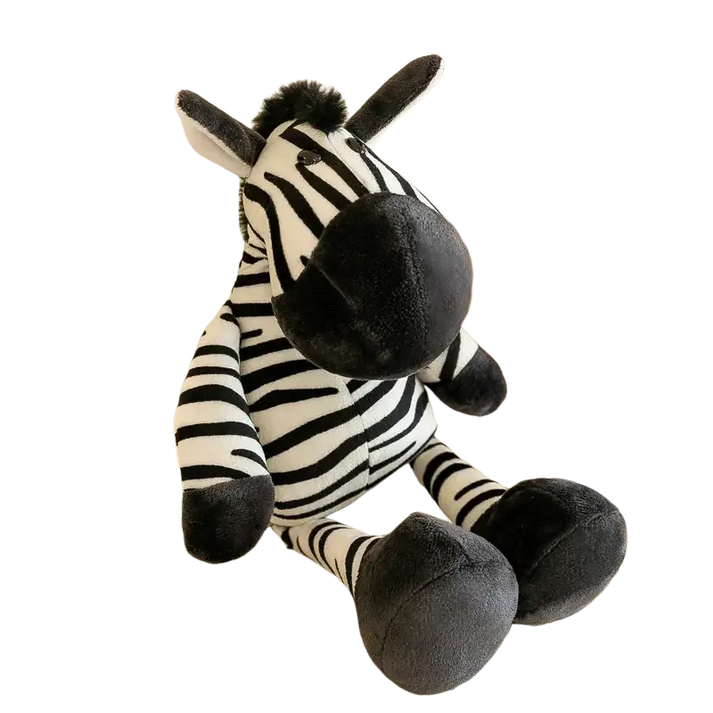 Plush jungle animal stuffed zebra toy with black and white striped fabric and soft gray felt ears and nose on lace tablecloth