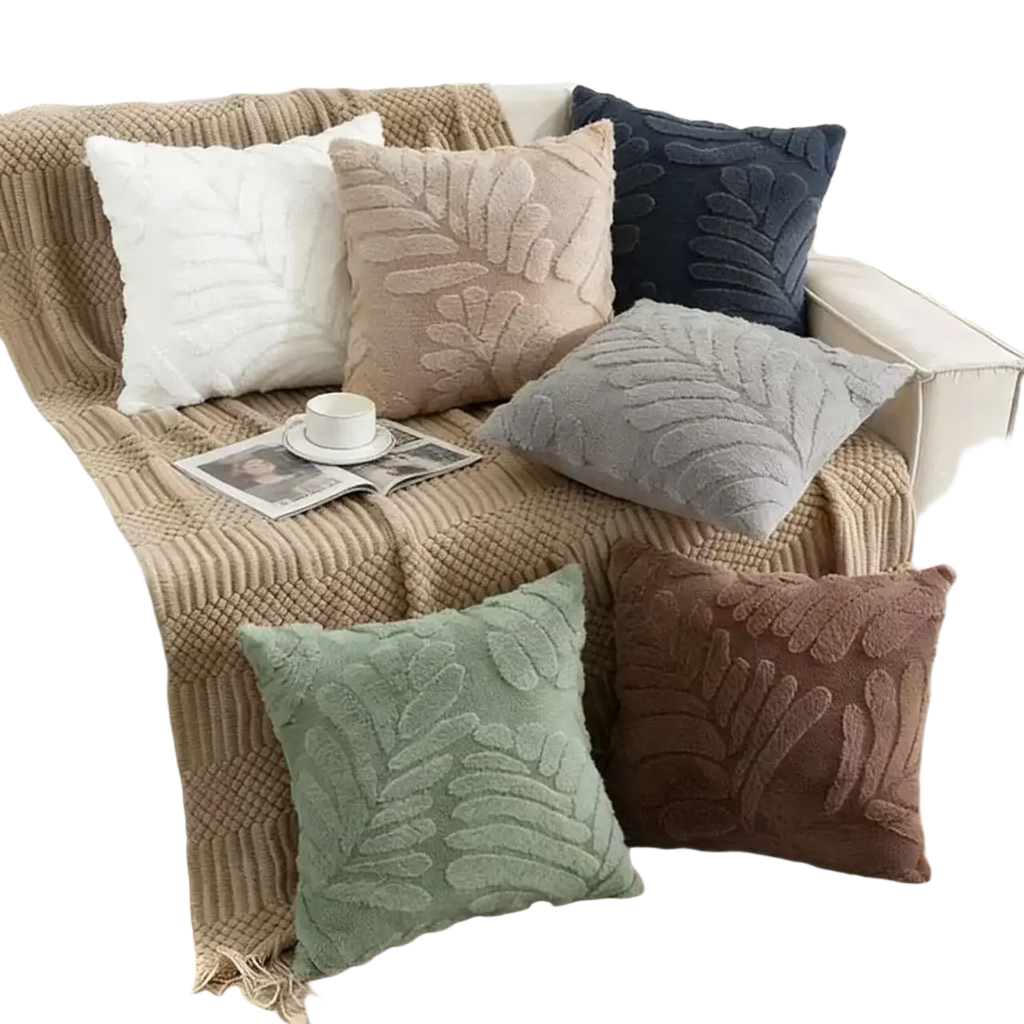 A cozy collection of plush leaf embroidered throw pillow covers in earthy tones with soft textured fabric