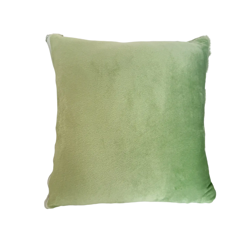 A soft sage green velvet plush leaf embroidered throw pillow cover with slightly frayed edges and square shape