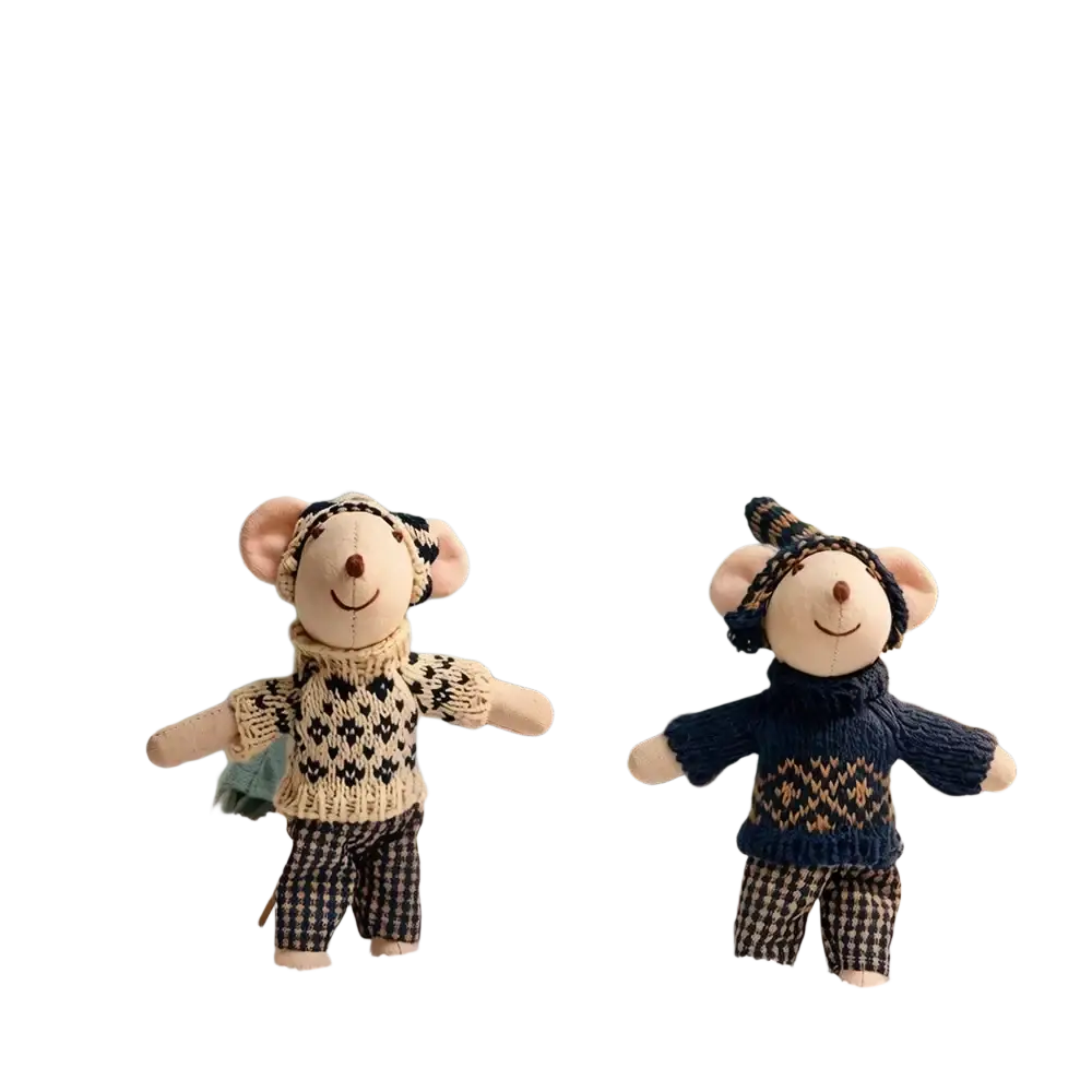 Two plush mouse doll stuffed animals dressed in knitted sweaters and checkered pants beside a blue teepee