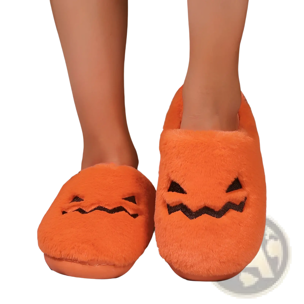 Plush pumpkin Halloween indoor slippers in orange fuzzy fabric with black embroidered facial features