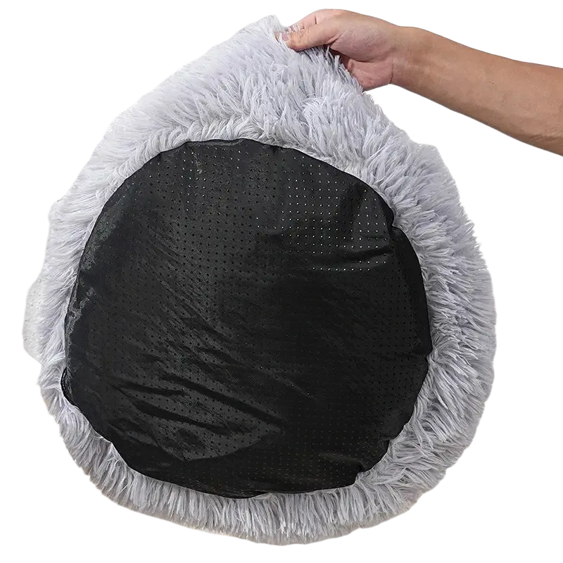 Gray plush round cat bed made of soft faux fur with a black perforated anti-slip bottom for pet comfort