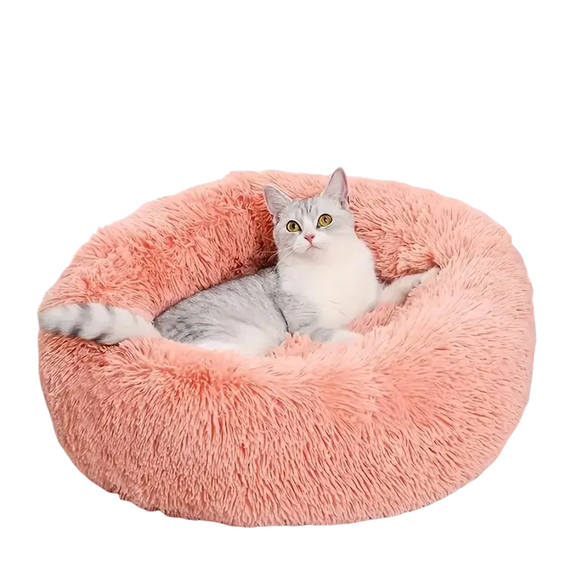 Soft pink plush round cat bed with fluffy texture designed as a warm and soft pet nest in gray tones