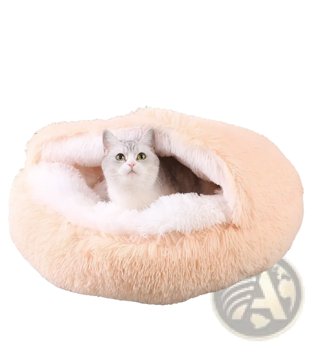 Plush round semi-enclosed cat bed in soft peach with a plush fabric and cozy white interior lining for comfort