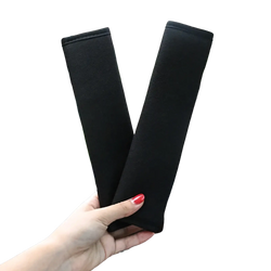Black plush fabric car seat belt cover designed as a shoulder pad for car seat comfort and protection