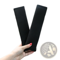 Black plush fabric car seat belt cover designed as a shoulder pad for car seat comfort and protection