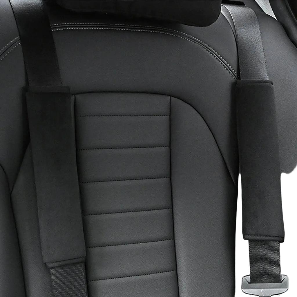 Black leather car seat with stitched detailing and plush black and pink padded seat belt shoulder covers
