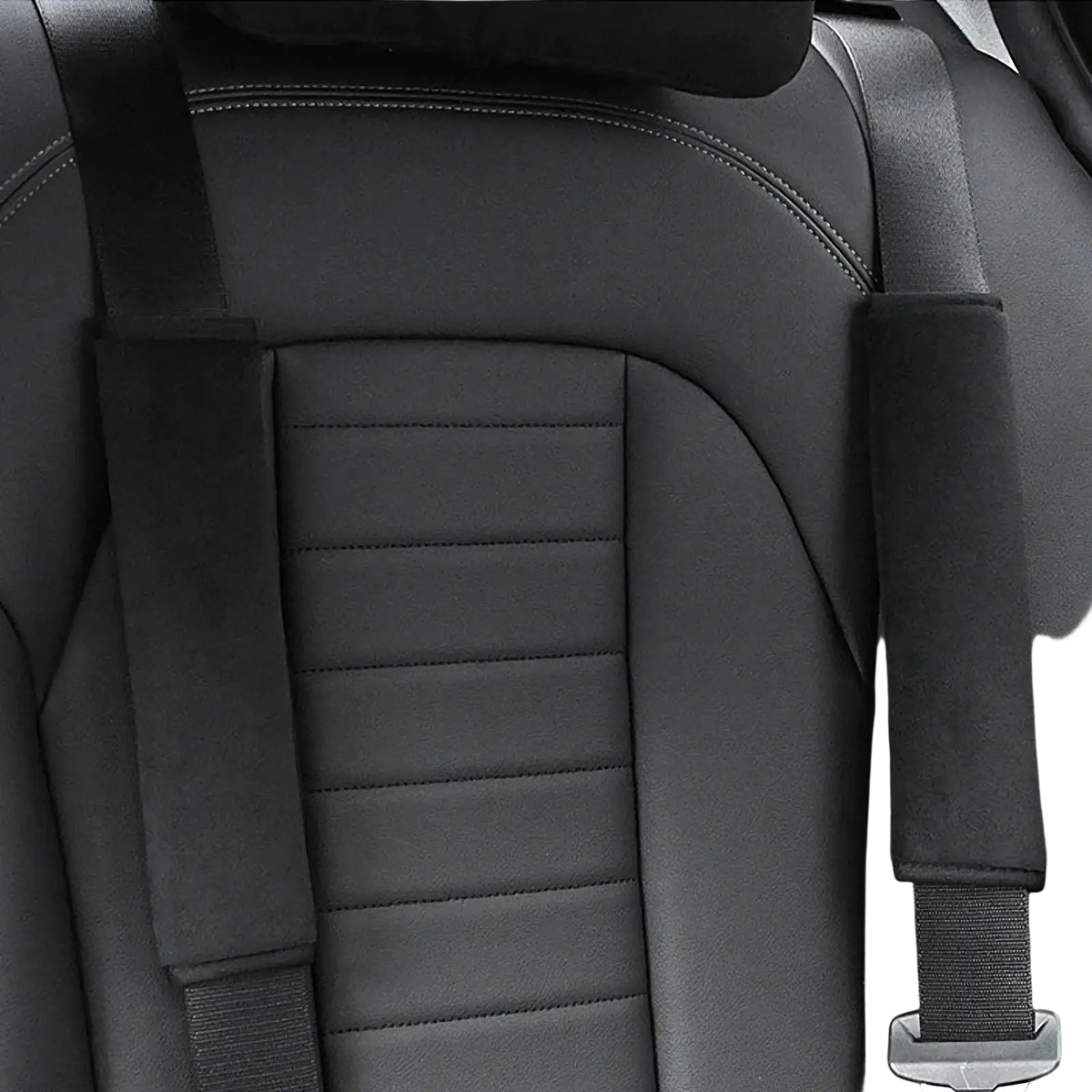 Black leather car seat with stitched detailing and plush black and pink padded seat belt shoulder covers