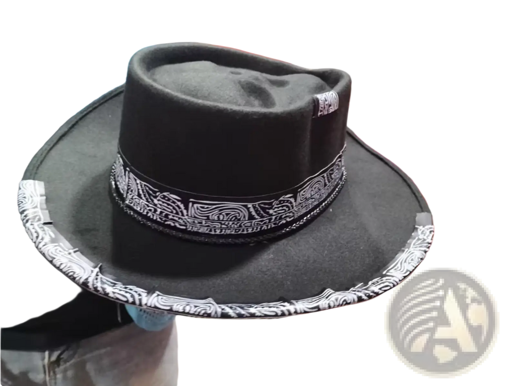 Plush skull cowboy hat in black felt with a wide brim and white patterned band around the crown