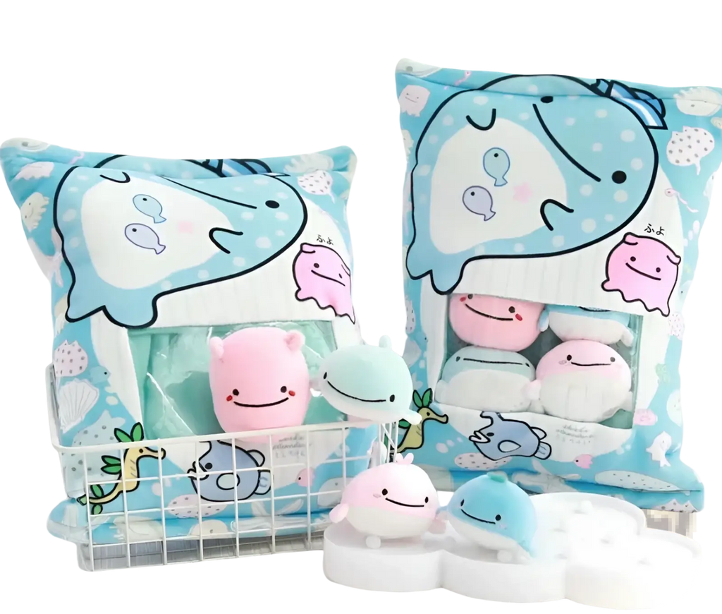 Blue and white whale-themed plush snack bag pillow with transparent front pocket holding eight small stuffed toys