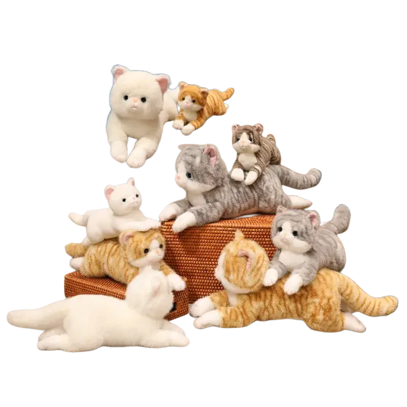 A collection of soft plush toys featuring cute kitten stuffed animals in white orange tabby gray tabby and calico colors