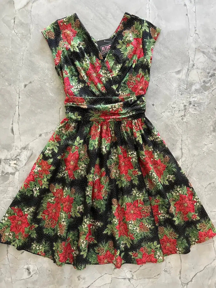 Poinsettia greta vintage floral cotton midi dress with pockets in black featuring red poinsettia flowers and v neck sleeveless design