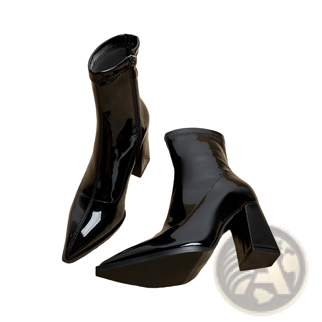 Black patent leather ankle boots with pointed toe and block heel shown from the back side