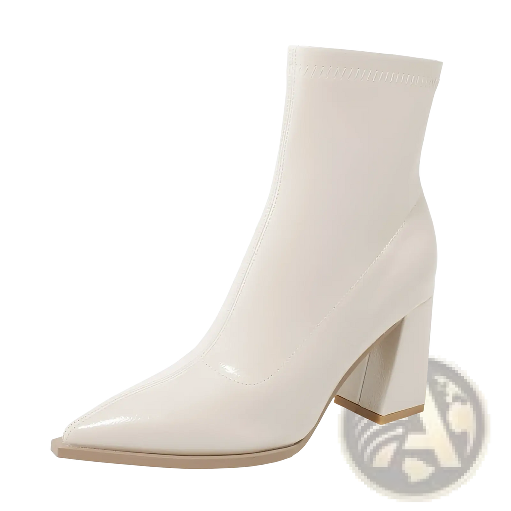 Cream-colored patent leather ankle boot with pointed toe and block heel shown from the back side