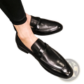 Polished dark brown leather british loafers in black with a polished finish and classic slip-on design
