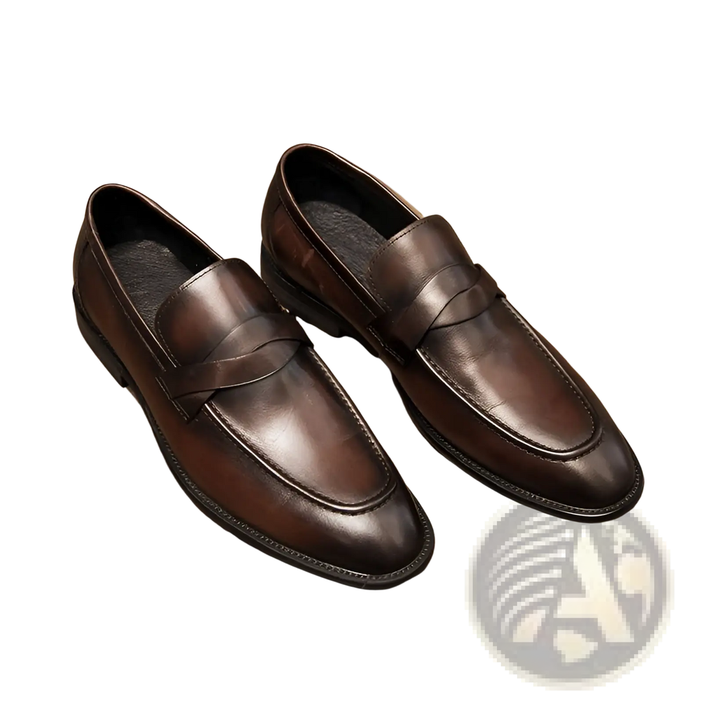 Pair of polished dark brown leather British loafers with classic slip-on design and smooth finish