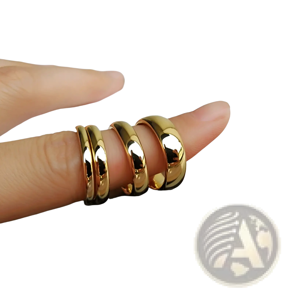 Four polished gold tungsten steel couple wedding bands in 2mm, 3mm, 4mm, and 6mm sizes displayed on a finger