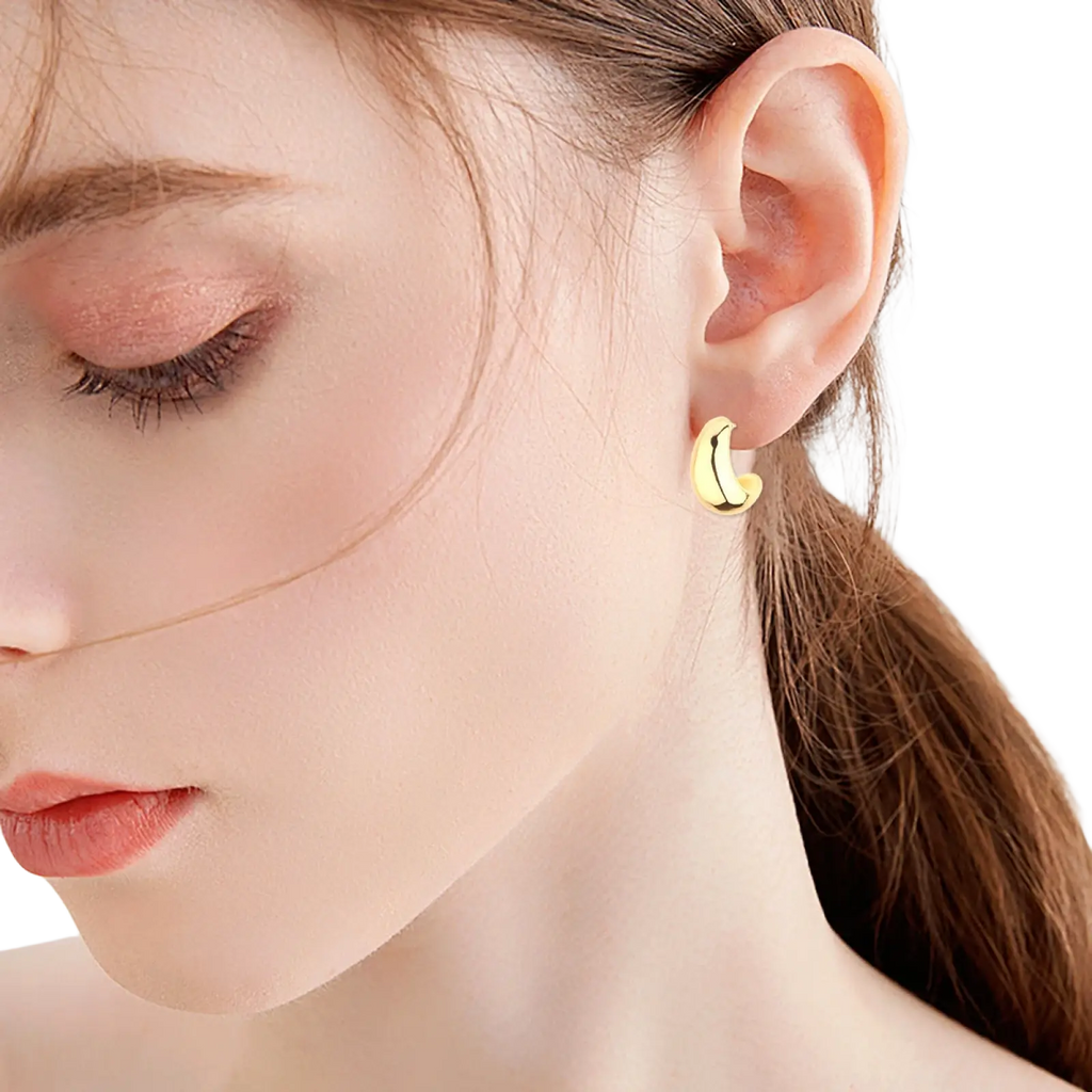 Polished gold twisted rope hoop earrings featuring minimalist crescent-shaped gold-colored design
