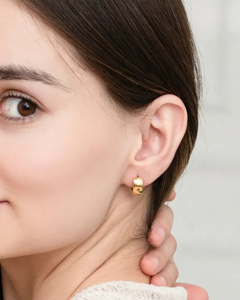 Polished gold magnetic rectangular hoop earring with a minimalist gold-toned design and smooth finish
