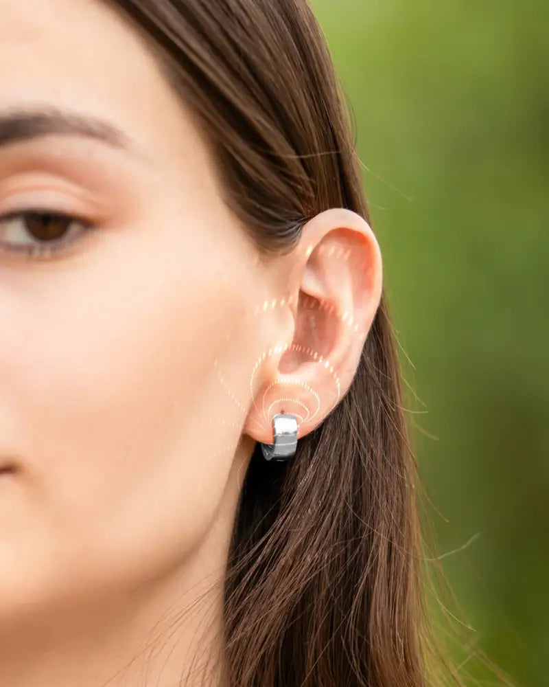 Silver-toned minimalist hoop earring with sleek modern design featuring polished silver magnetic neodymium therapy elements