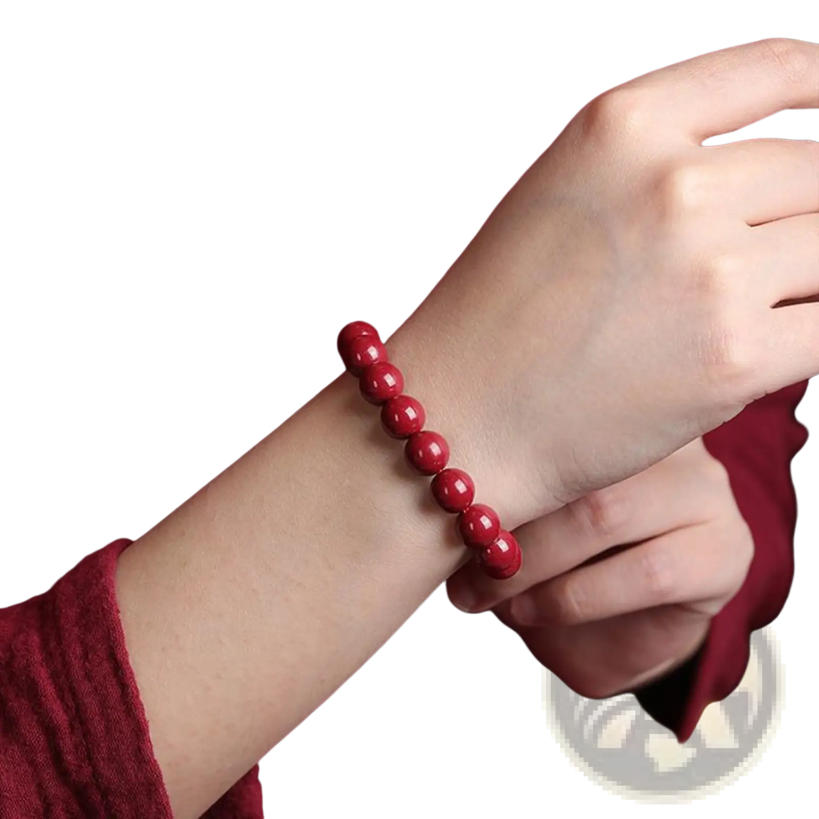 A vibrant red polished cinnabar spherical bead bracelet worn on a wrist showcasing its glossy finish