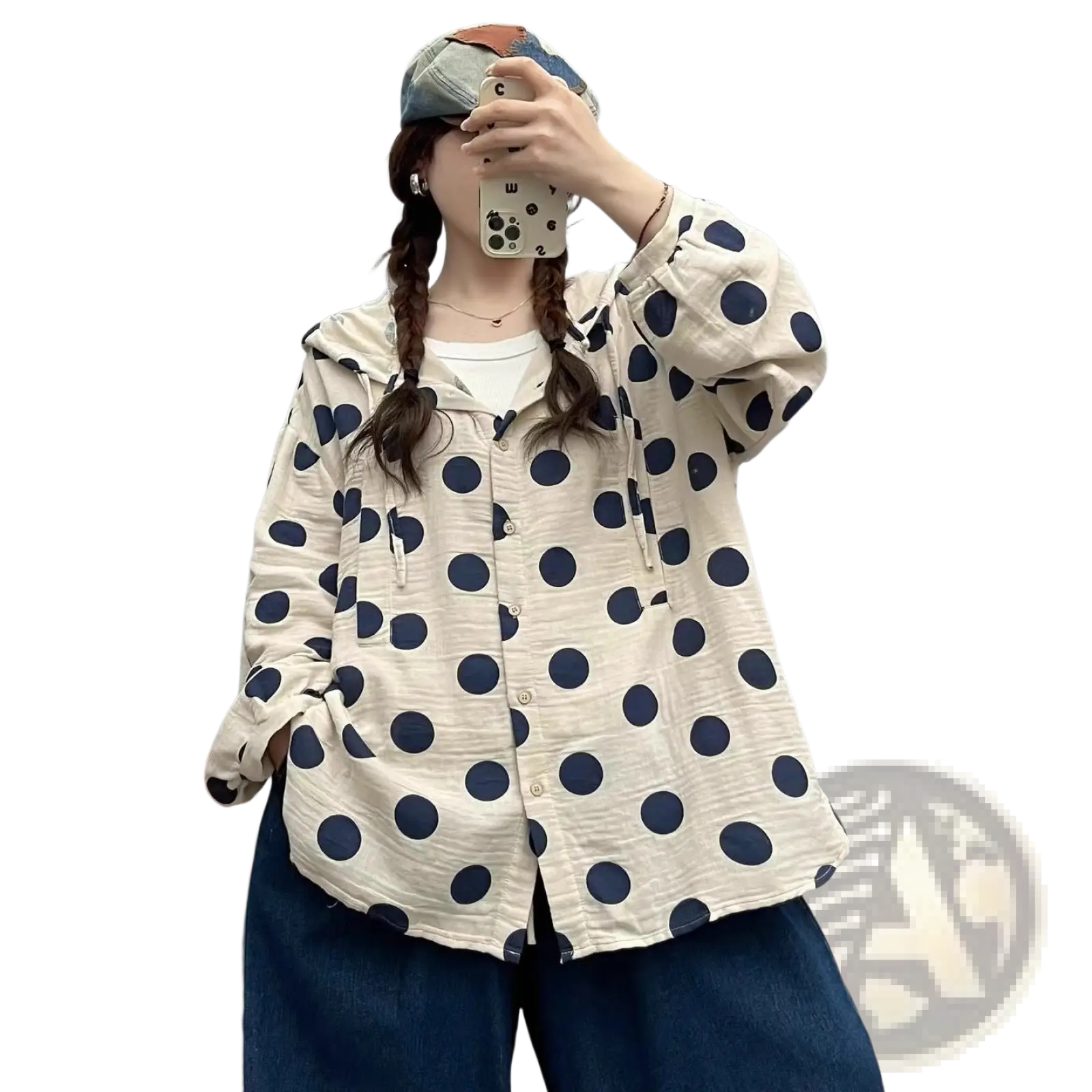 A cream-colored polka dot cardigan hoodie with navy blue dots and subtle textured fabric in long sleeves