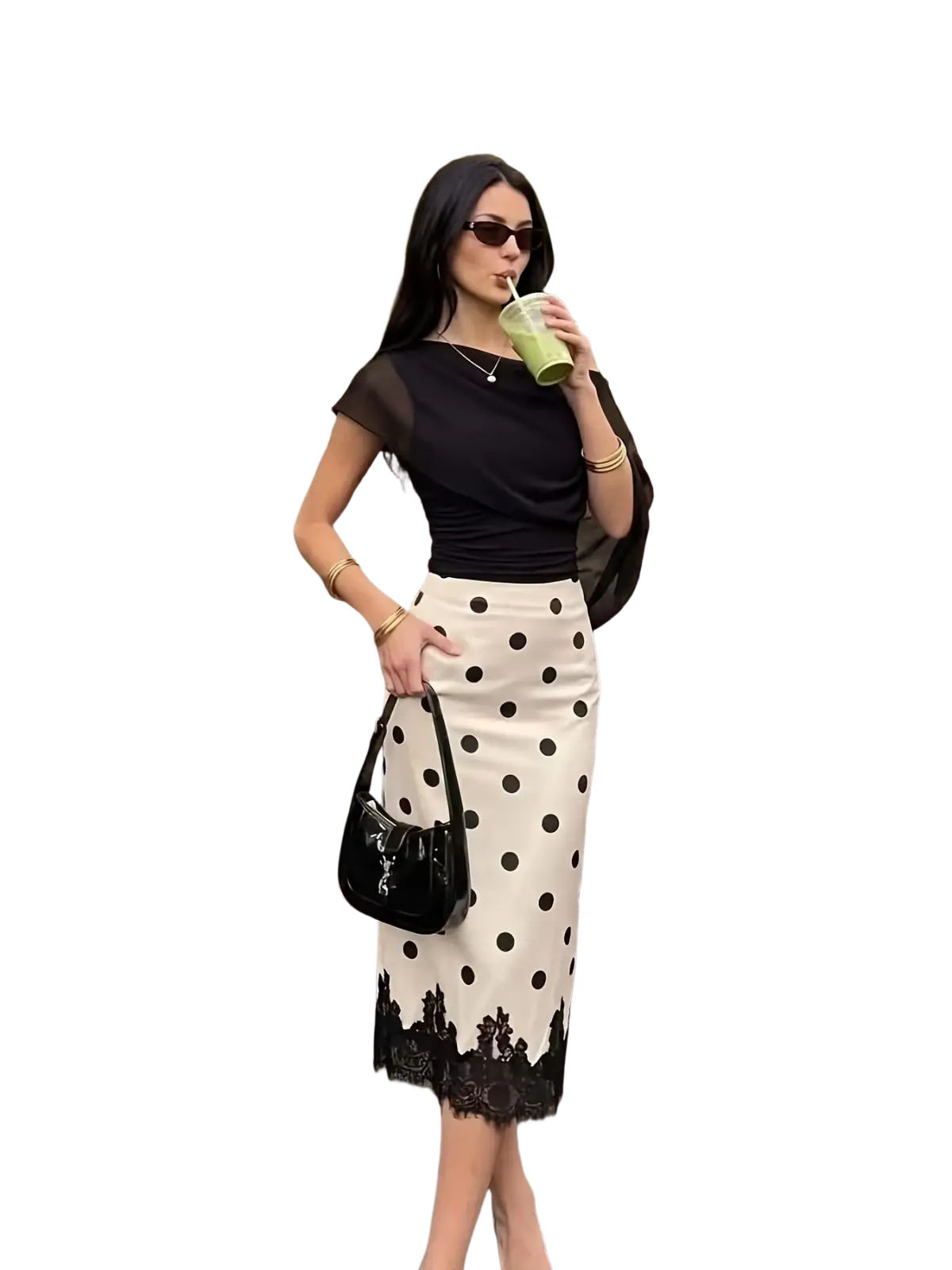 Black patent leather handbag with glossy finish and distinctive ysl logo paired with polka dot lace midi skirt