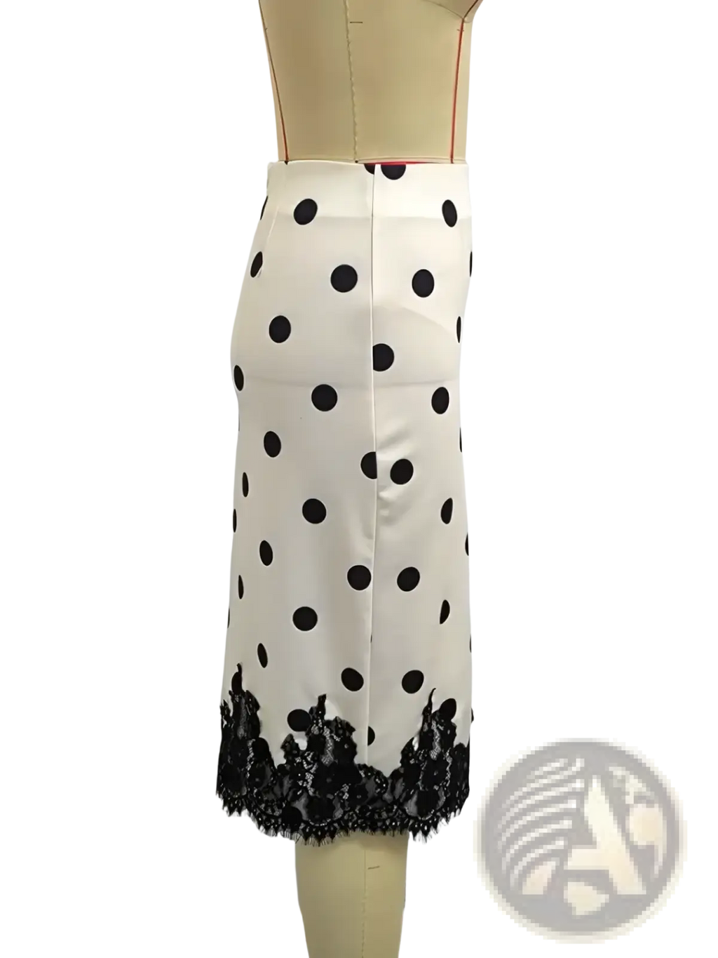 A white polka dot midi skirt with black lace trim at the hem combining elegance and classic style