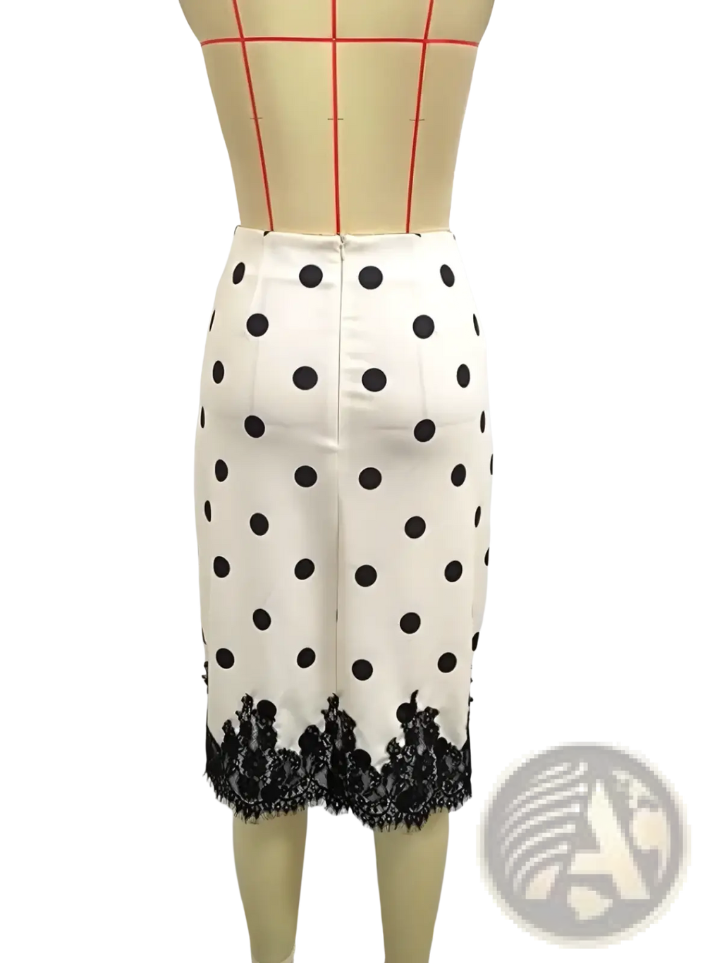 A white midi pencil skirt with black polka dots featuring a black lace trim at the hem
