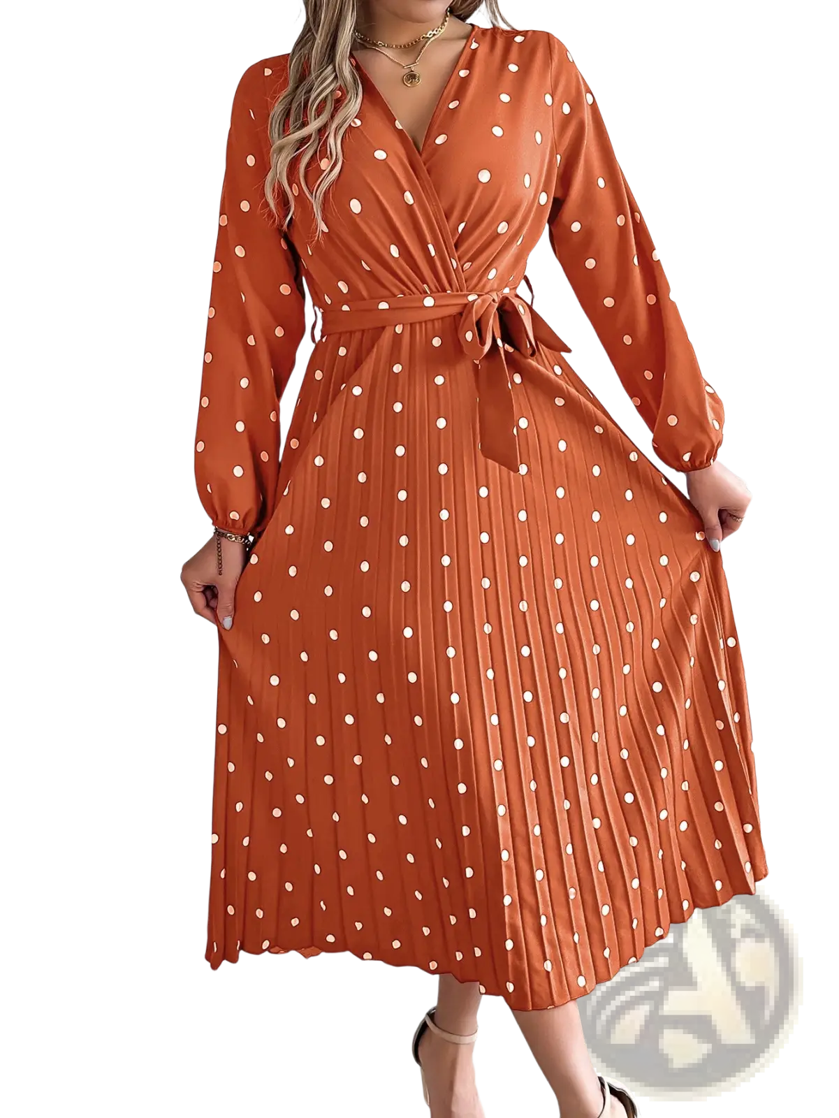A flowing orange polka dot pleated v neck long sleeve maxi dress with a self-tie belt and elegant silhouette