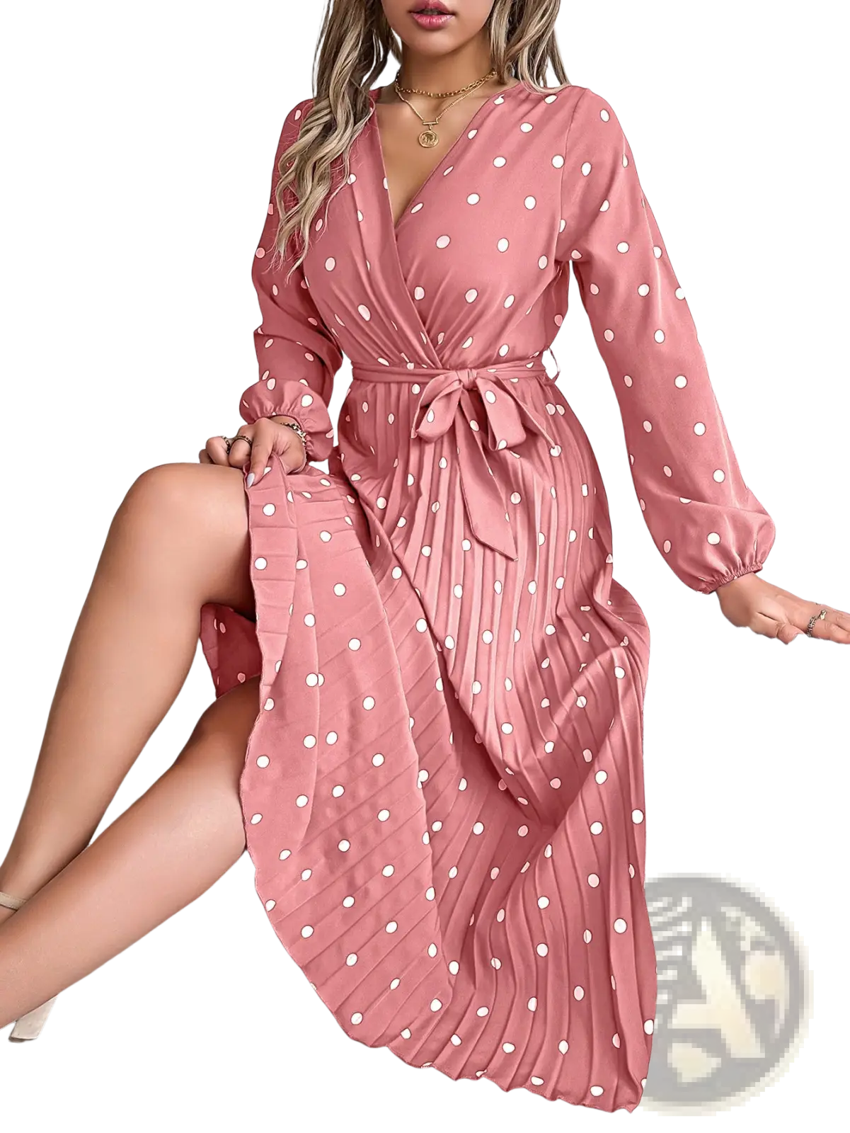 A flowing pink polka dot pleated v neck maxi dress with long sleeves and a self-tie belt