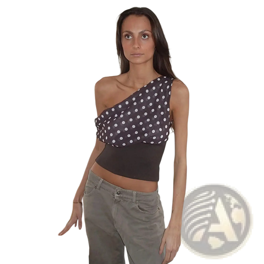 A dark gray chiffon polka dot one shoulder crop top featuring white dots and an asymmetric design