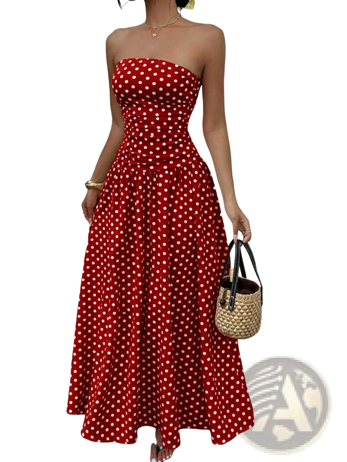 A vibrant red strapless maxi dress with white polka dots made from flowing fabric flaring gently at the hem
