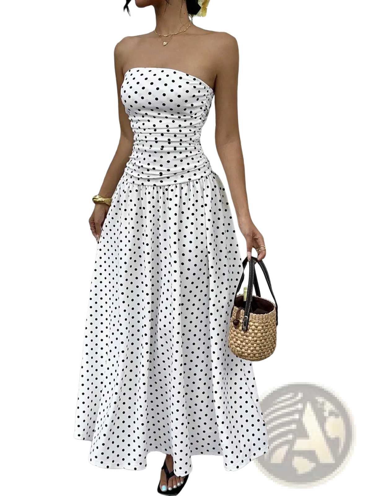 White strapless maxi dress with black polka dots featuring a ruched bodice and flowing skirt in lightweight fabric