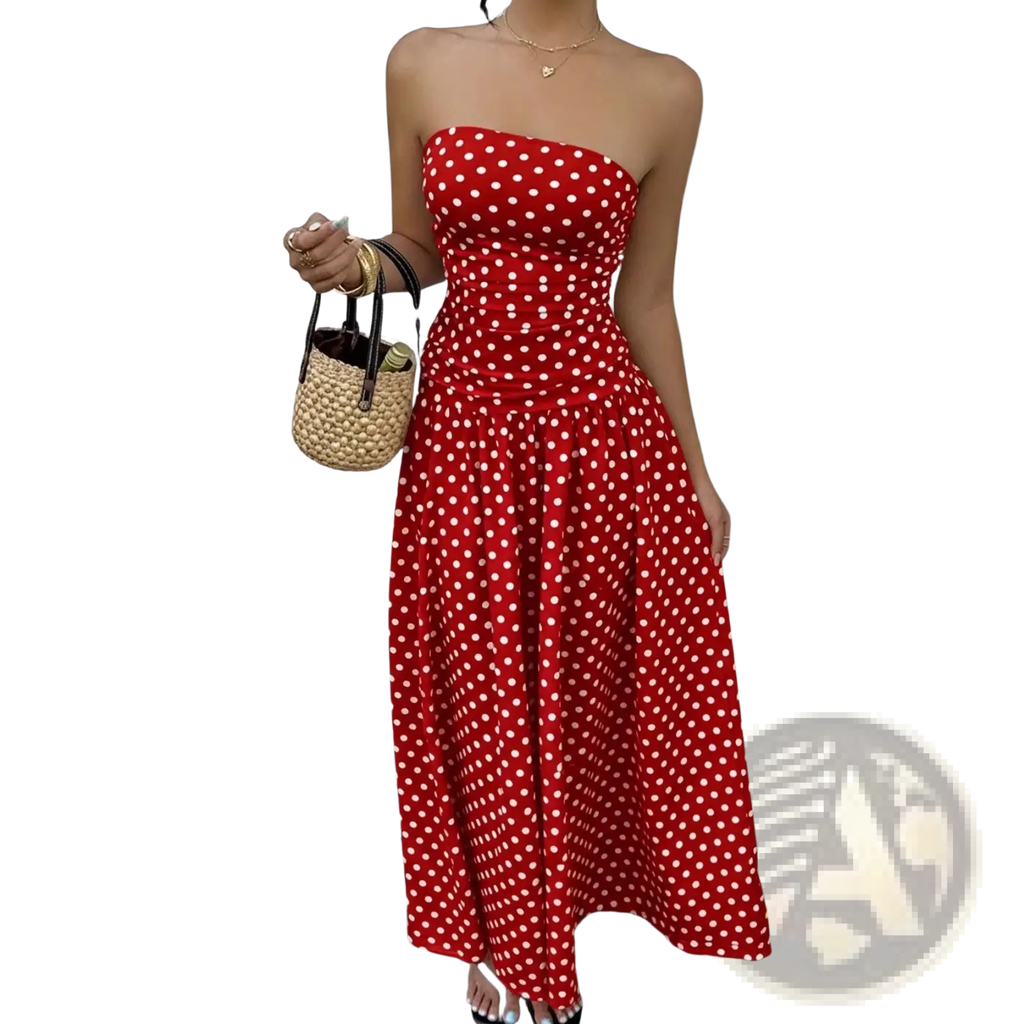 A vibrant red strapless maxi dress with white polka dots made from flowing fabric perfect for summer wear