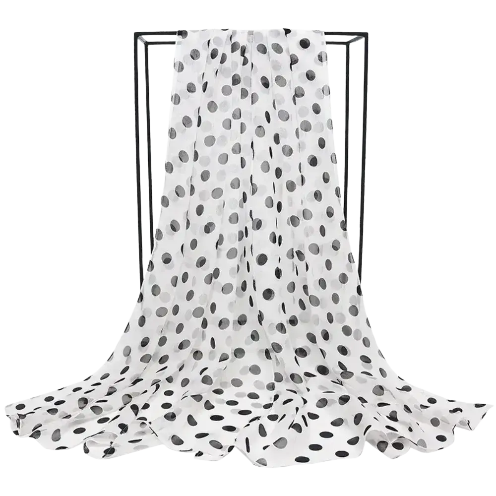 A flowing white chiffon head wrap scarf with black polka dots featuring a lightweight wrap scarf design