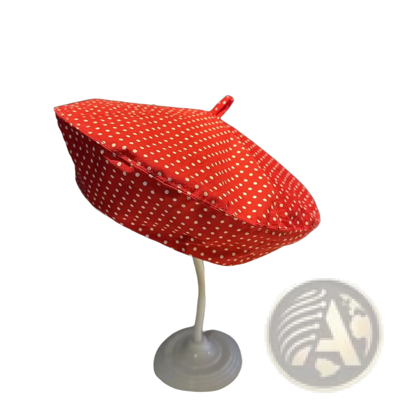 Red polka dot fabric beret with a small loop on top for sun protection in a baseball cap style