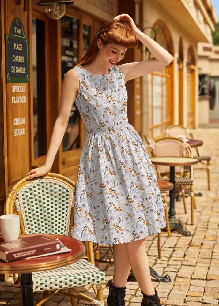Light blue Pollinators vintage cotton A-line dress with floral print, sleeveless design, fitted waist, flared skirt, and pockets