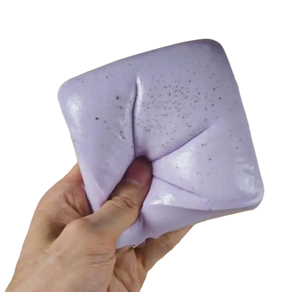 A soft lavender silicone squishy with dark speckles featured alongside a polyester acrylic winter scarf