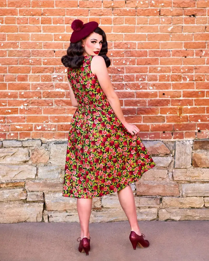 Pomegranate floral 1950s cotton swing midi dress with fitted bodice flared skirt sleeveless red and green vintage style